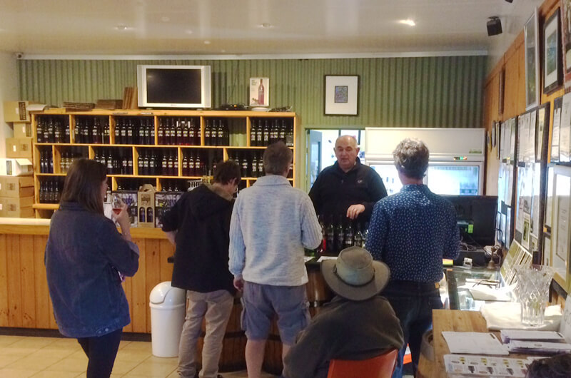 Griffith Tours New South Wales - photo of a tour group tasting wine at a Griffith winery cellar door.